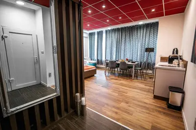 a living room with a table and a dining room at Oxford Apartments in Ljubljana