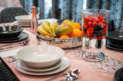 a table with a bowl of fruit on top of it at Oxford Apartments in Ljubljana