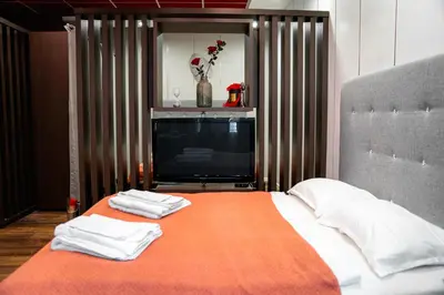 a bedroom with a bed with two towels on it at Oxford Apartments in Ljubljana
