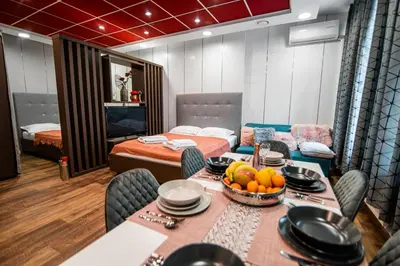 a dining room with a table with a bowl of fruit at Oxford Apartments in Ljubljana