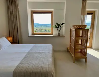 a bedroom with a bed and a window at Vipava View Studio Apartments in Šempas