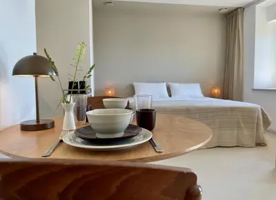 a coffee table with a bowl on top of a bed at Vipava View Studio Apartments in Šempas