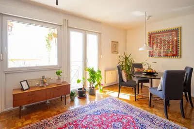 a living room with a table and a dining room at The Zen Apartment in Ljubljana