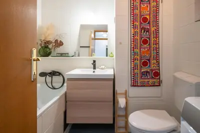 a bathroom with a sink and a toilet and a mirror at The Zen Apartment in Ljubljana
