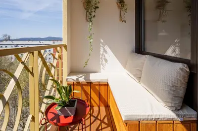 a balcony with a bench and a potted plant at The Zen Apartment in Ljubljana