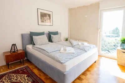 a bedroom with a bed with two towels on it at The Zen Apartment in Ljubljana