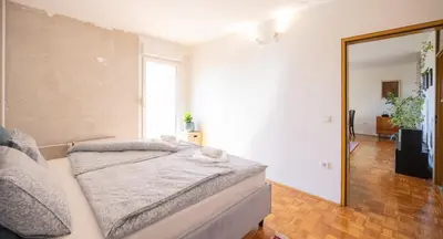 a bedroom with a bed and a mirror at The Zen Apartment in Ljubljana