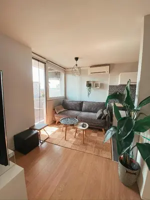 a living room with a couch and a table at Charming Apartment Siska in Ljubljana