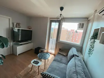 a living room with a couch and a tv at Charming Apartment Siska in Ljubljana