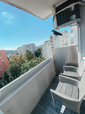 a balcony with two chairs and a view of a city at Charming Apartment Siska in Ljubljana