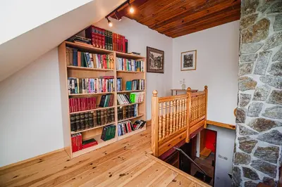 a room with a book shelf filled with books at Kaval Home with Free Onsite Wellness in Dravograd