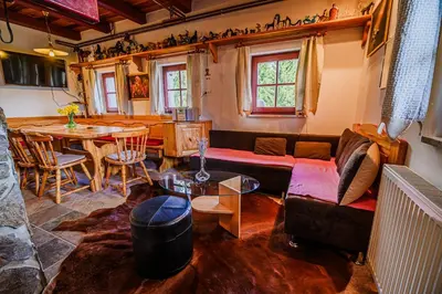 a living room with a couch and a table at Kaval Home with Free Onsite Wellness in Dravograd