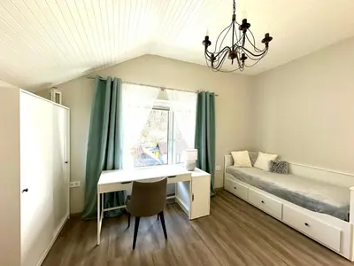 a bedroom with a bed and a desk and a window at Sunny 3-room apartment with a terrace in Ljubljana
