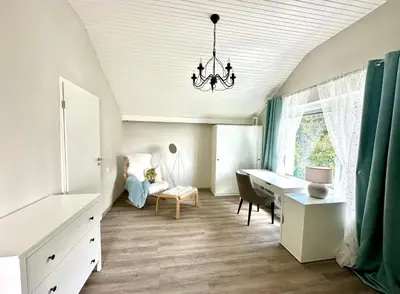 a living room with a desk and a chair at Sunny 3-room apartment with a terrace in Ljubljana