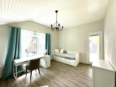 a bedroom with a desk and a bed and a desk and a window at Sunny 3-room apartment with a terrace in Ljubljana