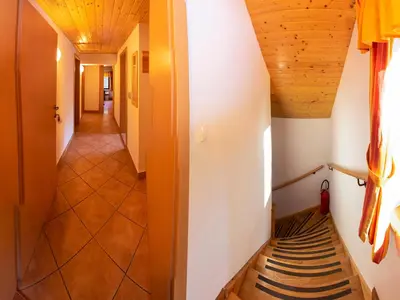 a hallway in a house with wooden ceilings at Digital Detox Chalet Pokljuka in Goreljek