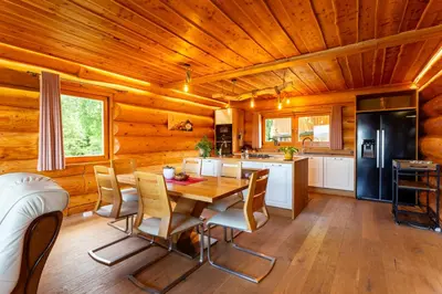 a kitchen and dining room with a wooden ceiling at Villa Harmonia Private Jacuzzi and Pool Retreat near Rogaška in Rogatec