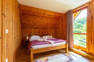 a bedroom with a bed in a log cabin at Villa Harmonia Private Jacuzzi and Pool Retreat near Rogaška in Rogatec