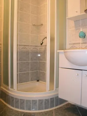 a bathroom with a shower and a sink at Guest House and Museum Firšt in Solčava