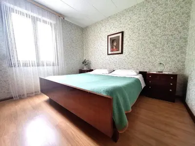 a bedroom with a large bed and a window at Apartma Ferjan in Žaga