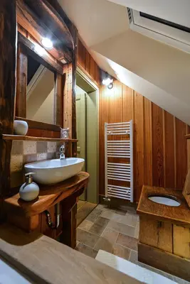 a bathroom with a sink and a mirror at Villa Les with Hot tub & Sauna in Brežice