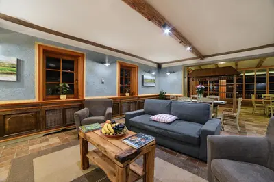a living room with a couch and a table at Villa Les with Hot tub & Sauna in Brežice
