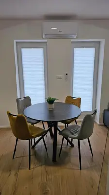 a table and chairs in a room with a table and chairs at Apartment Kranjc in Cerknica