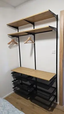 a black shelving unit in a bedroom at Apartment Kranjc in Cerknica