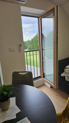 a room with a table and a view of a balcony at Apartment Kranjc in Cerknica