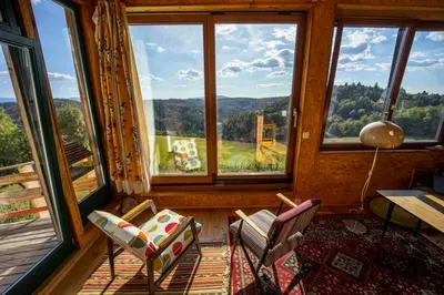 a room with two chairs and a table and windows at ELIAS Residency in Rob