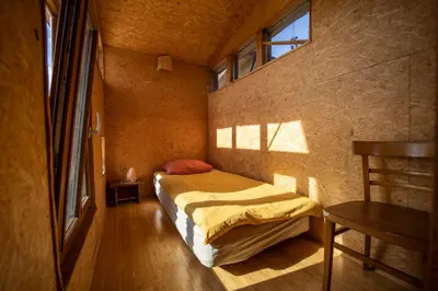 a small bedroom with a bed and a window at ELIAS Residency in Rob