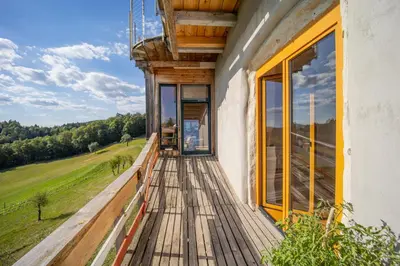 a porch of a house with a view of a field at ELIAS Residency in Rob