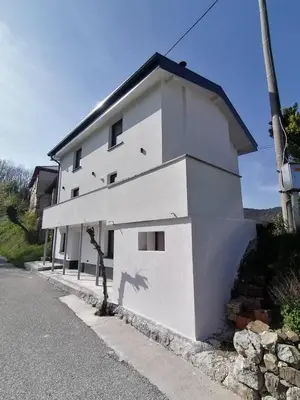 a white building on the side of a street at Apartments Stella Vittoria in Ročinj