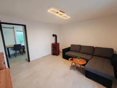 a living room with a couch and a table at Apartments Stella Vittoria in Ročinj
