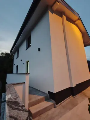 a house with a staircase leading up to it at Apartments Stella Vittoria in Ročinj
