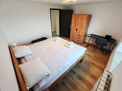a bedroom with a bed with a desk and a piano at Apartments Stella Vittoria in Ročinj