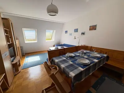 a dining room with a table with plates on it at Apartma Lisjak in Bovec