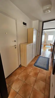 a room with a kitchen with a door and a tile floor at Apartma Lisjak in Bovec