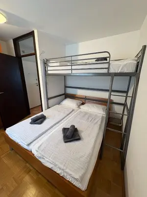 a bedroom with a bunk bed with two hats on it at Apartma Lisjak in Bovec