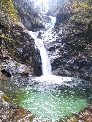 a waterfall on the side of a mountain with a pool of water at Krtajse in Slappe dʼIdria