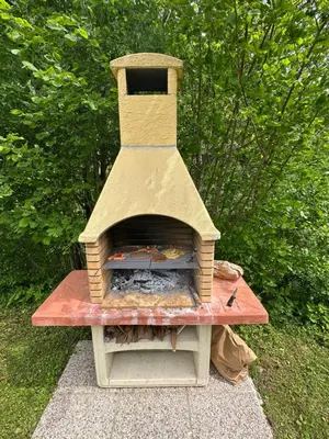 a brick oven sitting on top of a table at Krtajse in Slappe dʼIdria