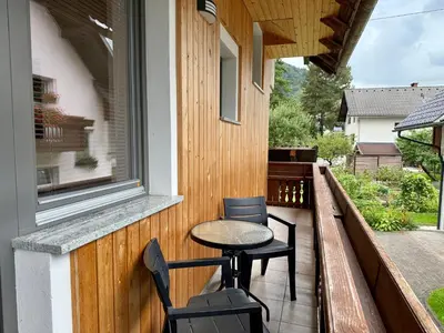 a patio with a table and chairs on a balcony at Apartma Lilly in Bohinjska Bela