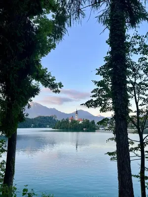 a view of a lake with a church in the middle at Apartma Lilly in Bohinjska Bela