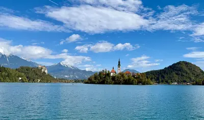 a castle on an island in the middle of a lake at Apartma Lilly in Bohinjska Bela