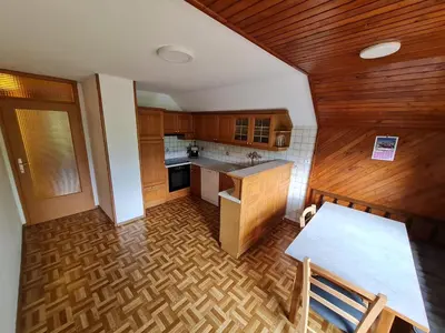 an overhead view of a kitchen with wooden cabinets at Apartma Grm in Bohinj