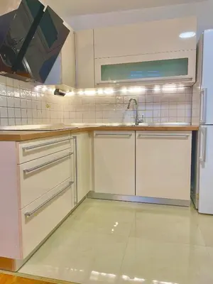 a kitchen with white cabinets and a sink at Topel dom v centru mesta 5 in Maribor