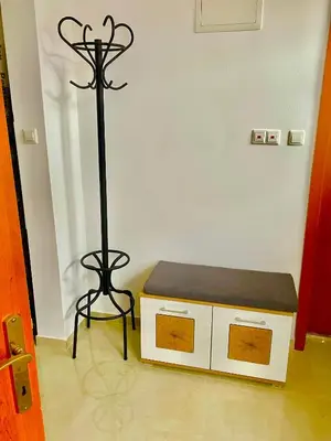 a bench and a stand in a room at Topel dom v centru mesta 5 in Maribor