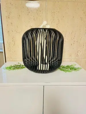 a black and white vase sitting on top of a counter at Topel dom v centru mesta 5 in Maribor