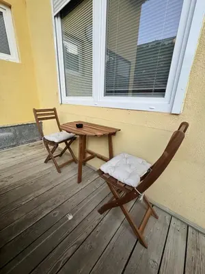 a patio with a table and chairs on a deck at Basilica in Maribor