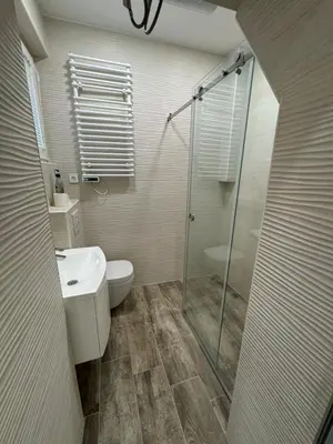 a bathroom with a shower and a toilet and a sink at Basilica in Maribor
